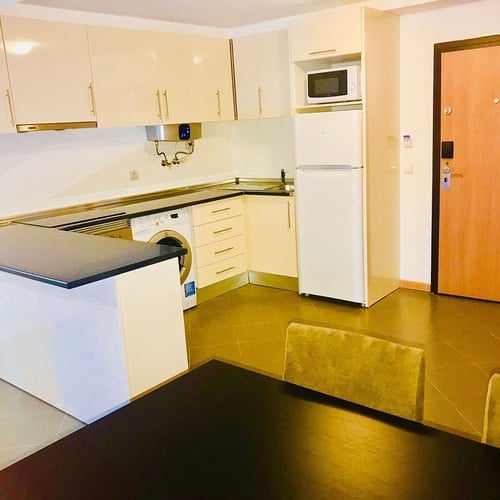 a kitchen with a fire extinguisher on the wall