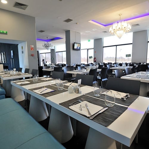 a restaurant with many tables and chairs and a sign that says fire exit