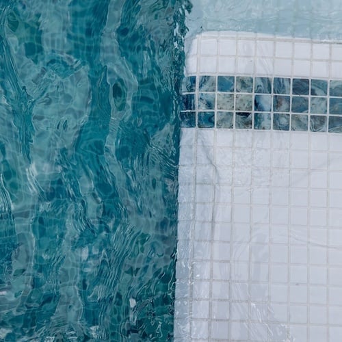a swimming pool with blue tiles and white tiles