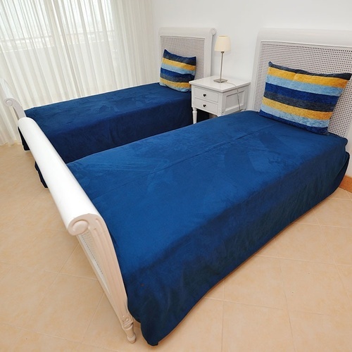 a bedroom with two twin beds and a nightstand