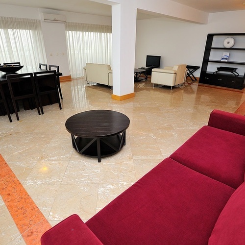a living room with a red couch and a table