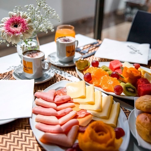 a table with plates of food and a napkin that says my guest