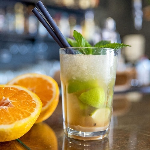 a close up of a drink with straws on a table