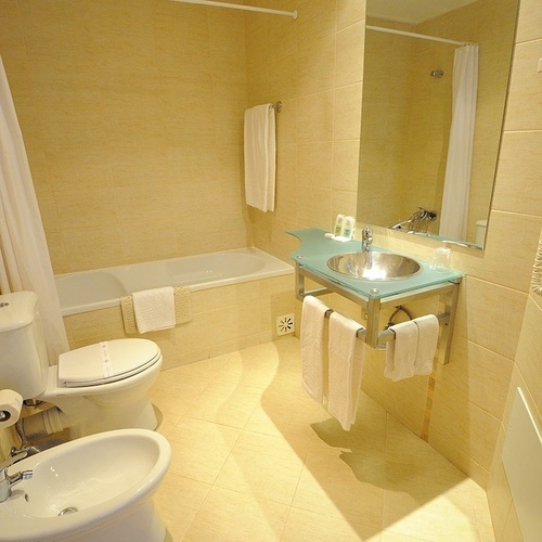 a bathroom with a toilet a bidet and a sink