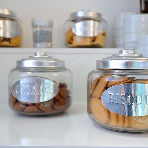 two glass jars filled with cookies and biscuits