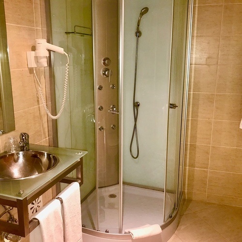 a bathroom with a sink and a shower stall