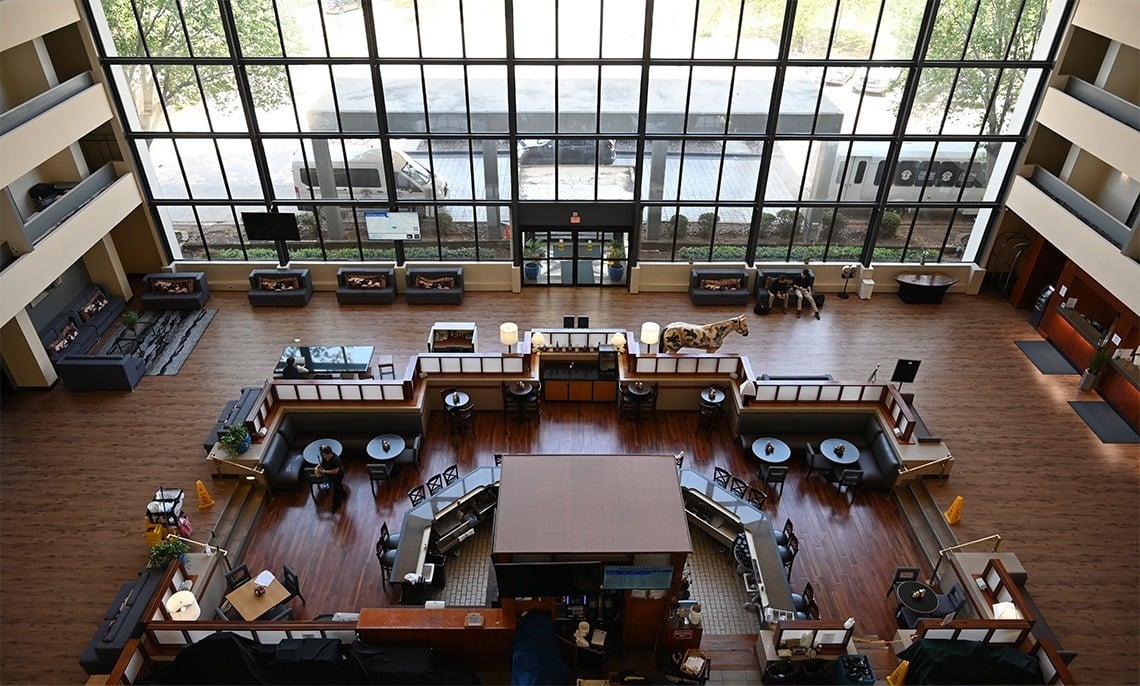 an aerial view of a hotel lobby with tables and chairs
