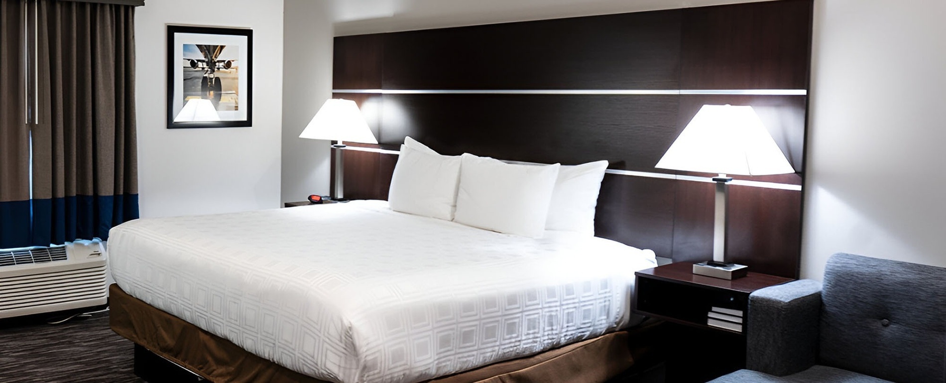 a hotel room with a bed and two lamps