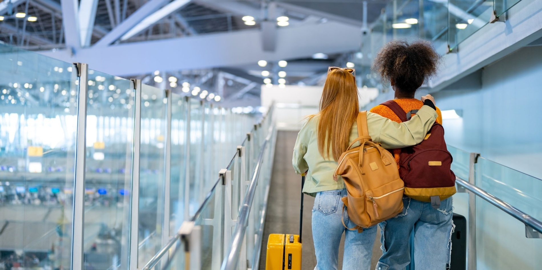 a woman sits at a table using a laptop computer