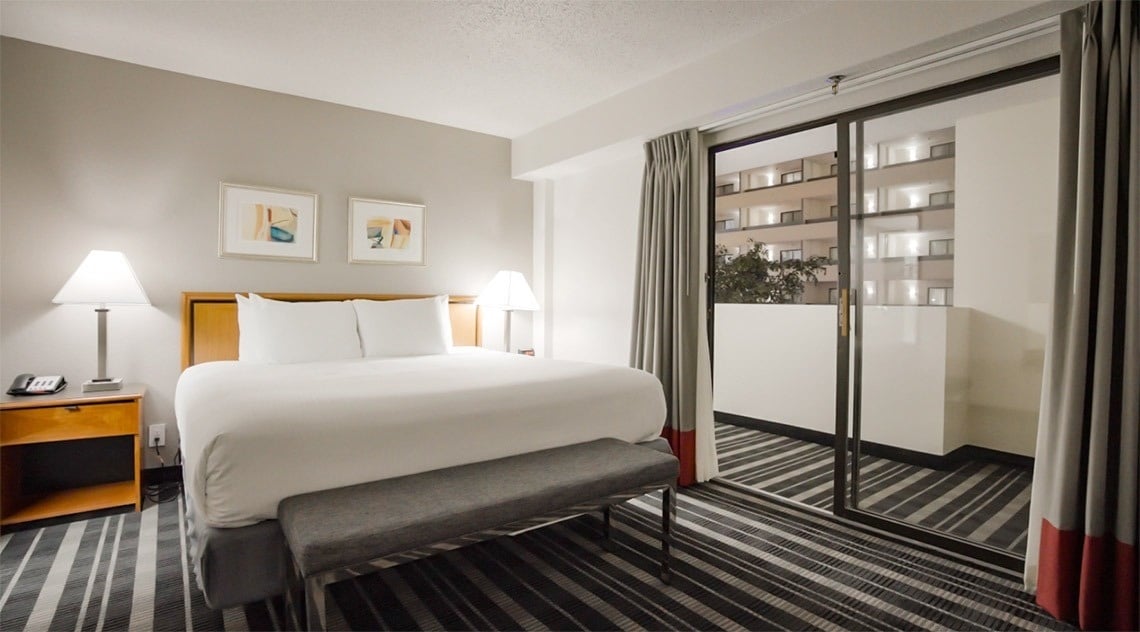 a hotel room with a bed and a mirror