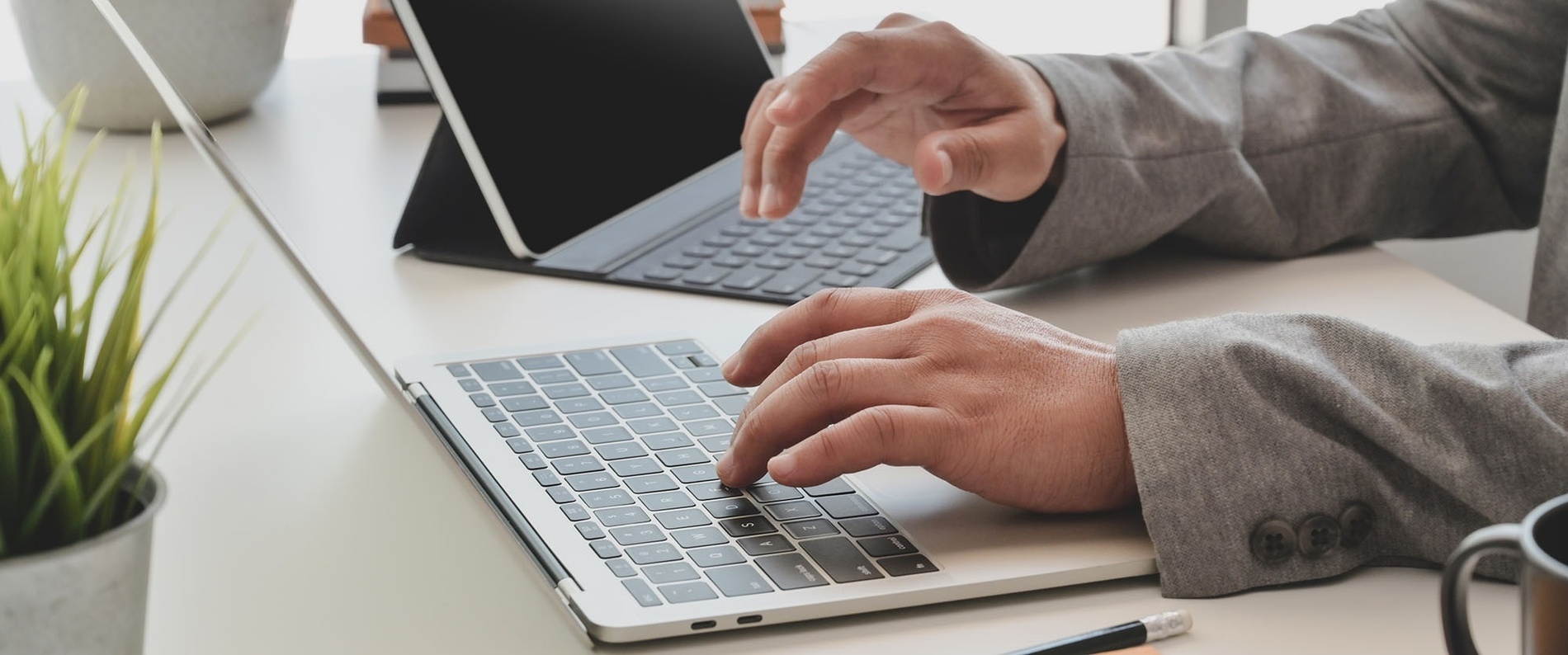 un hombre está usando una computadora portátil y una tableta