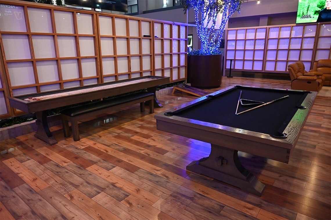 a pool table and a shuffleboard table in a room