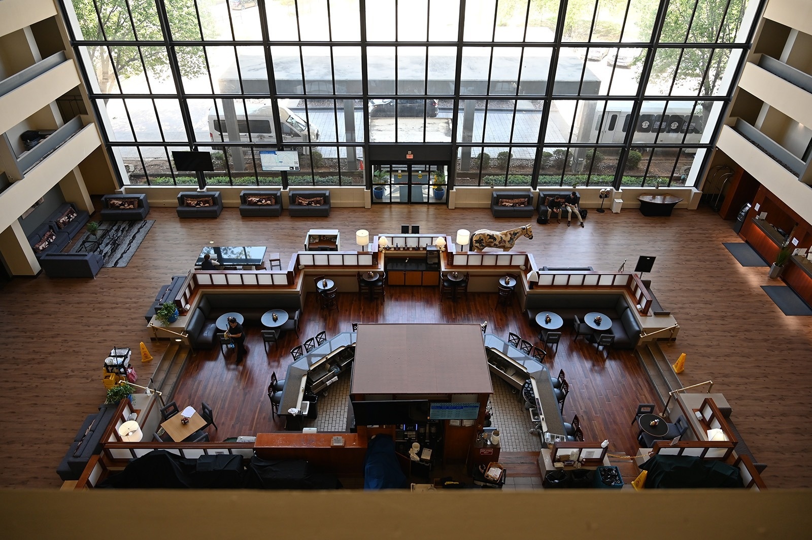 a hotel lobby with a bar and people sitting at tables