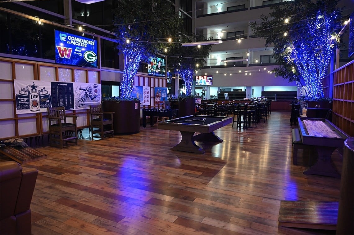 a large room with a pool table and a sign that says ' commanders ' on it