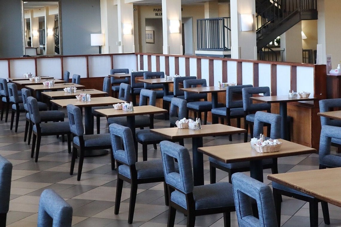 tables and chairs in a restaurant with the word park on the wall