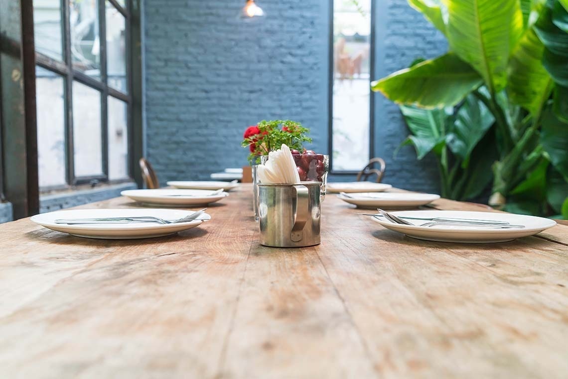 a living room with a couch and chairs and a clock on the wall