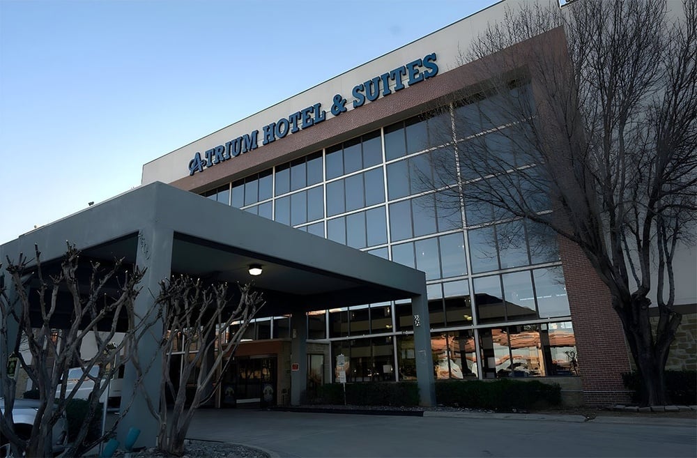 atrium hotel and suites building with lots of windows