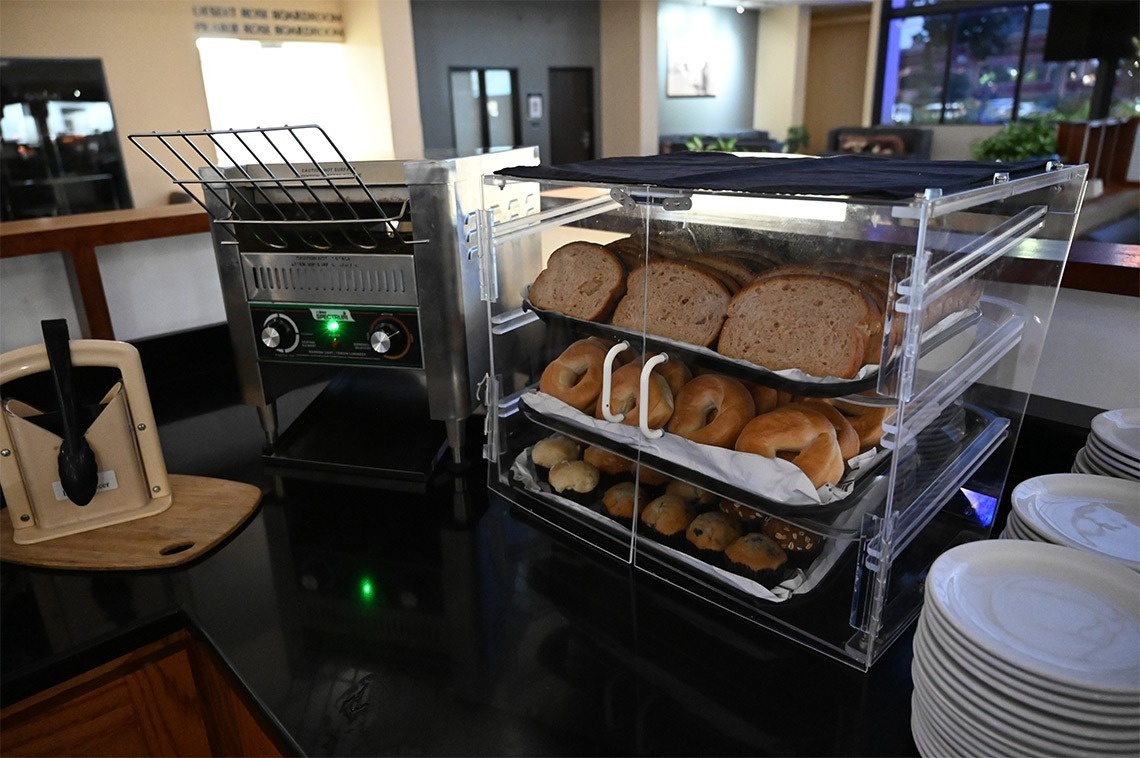 a display of bread and bagels next to a toaster