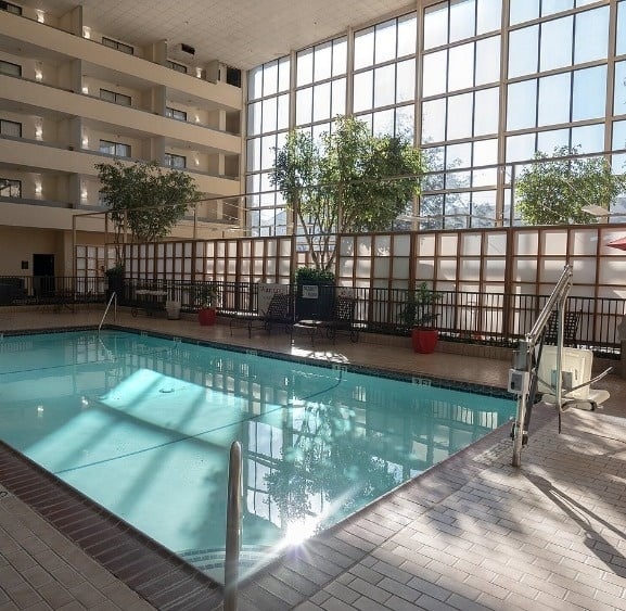 a large indoor swimming pool with a sign that says no diving