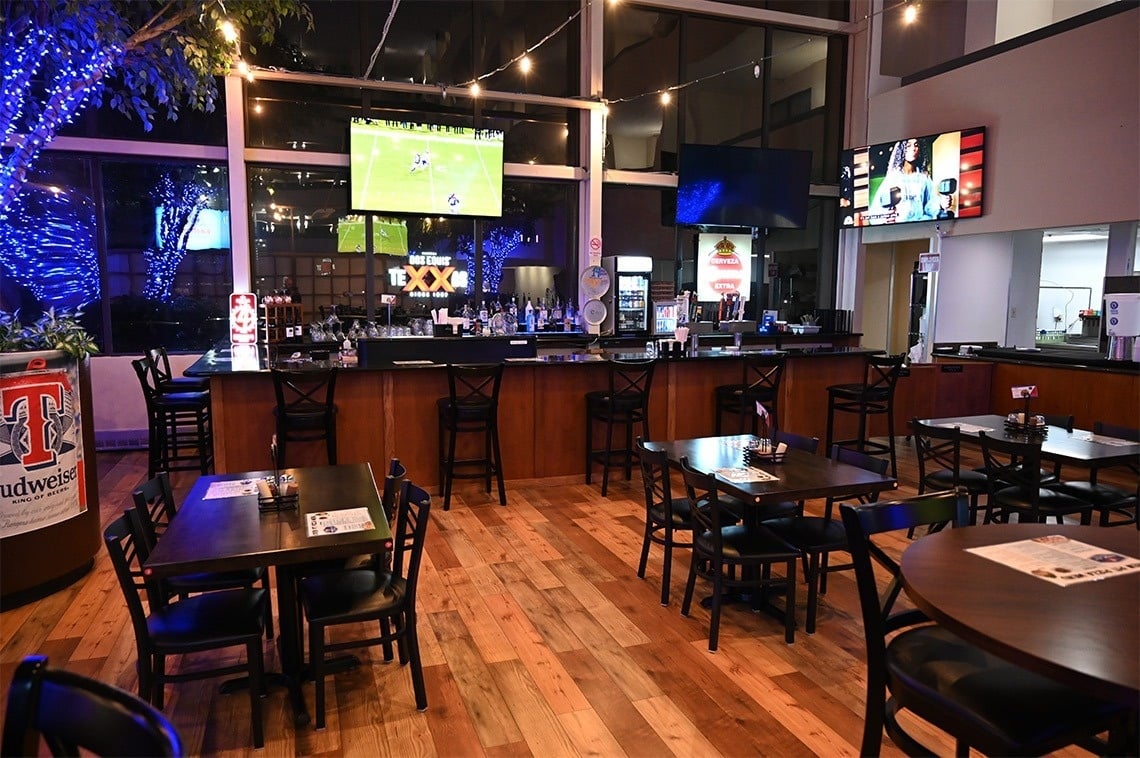 a bar with a budweiser sign in front of it