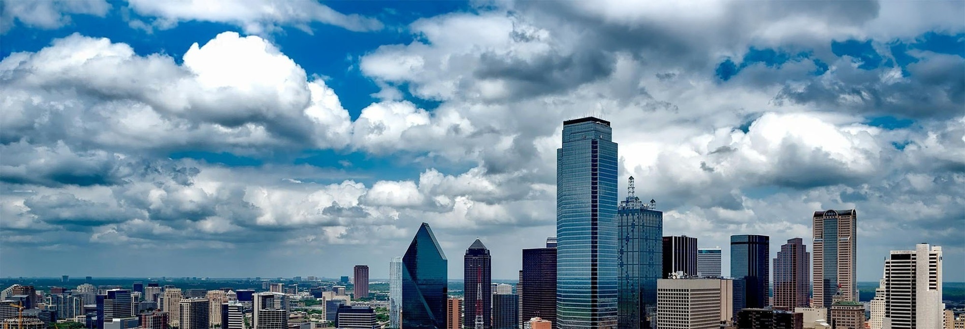 a woman sits at a table using a laptop computer