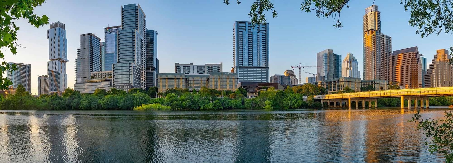 a waterfall in a park with a tall building in the background