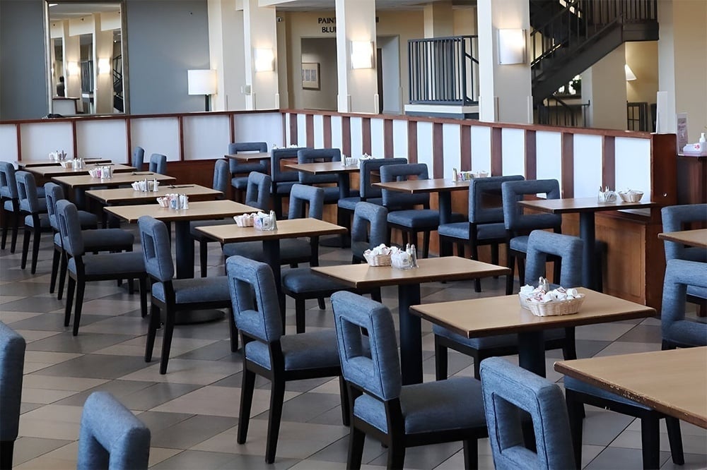 a restaurant with tables and chairs and a sign that says park plaza