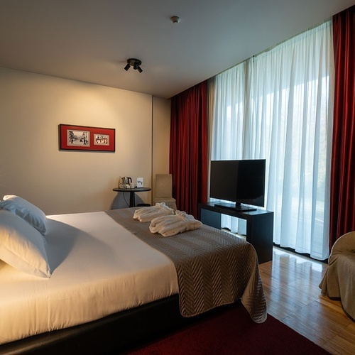 a hotel room with a large bed and a television