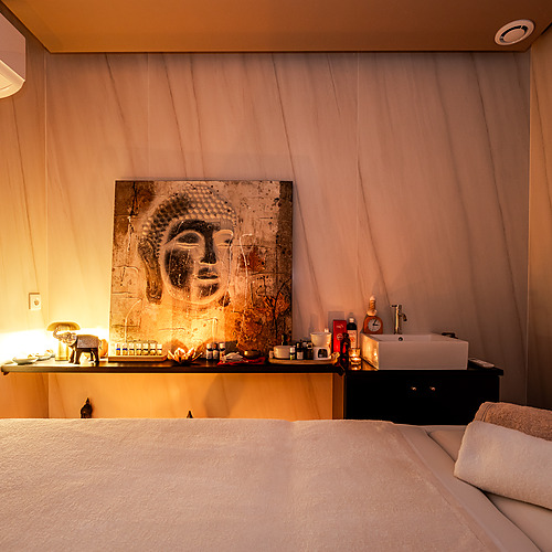 Relájate en nuestra Axis: Corporate spa: cama de masaje, arte de Buda, lavabo y toallas.