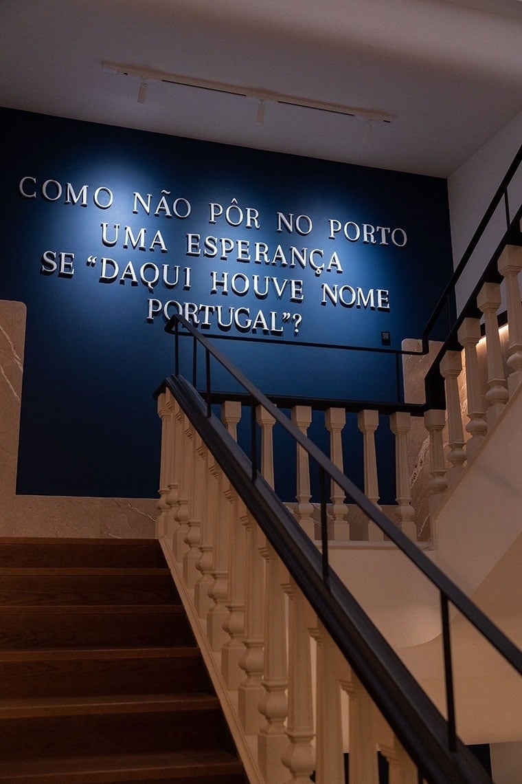 a staircase with a blue wall that says 