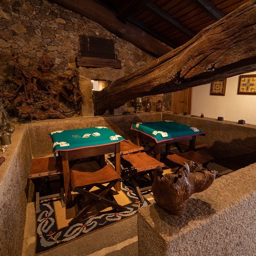 a room with a table and chairs with playing cards on them
