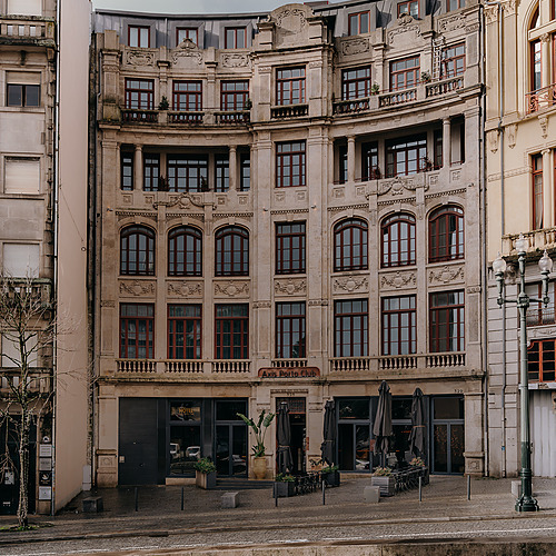 Axis: Corporate: Edifício histórico curvo com fachada de pedra, arquitetura europeia.