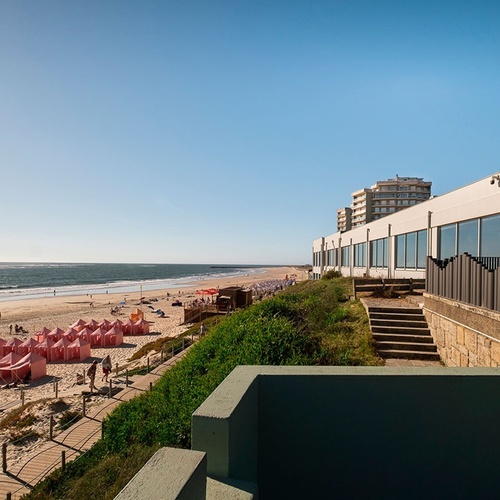 a view of a beach with a building in the background
