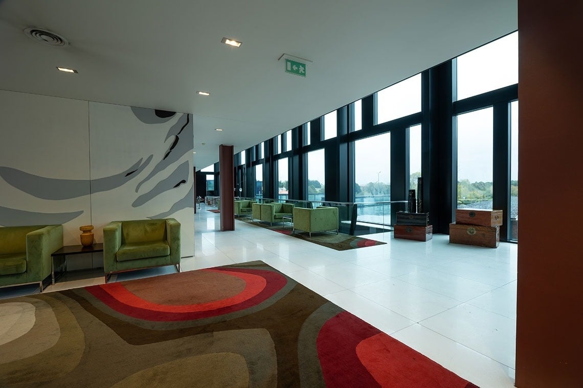 a room with a green exit sign on the ceiling