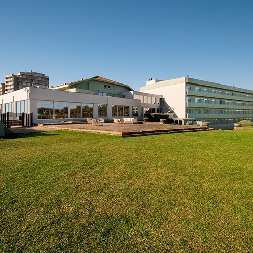 a large building with a lawn in front of it