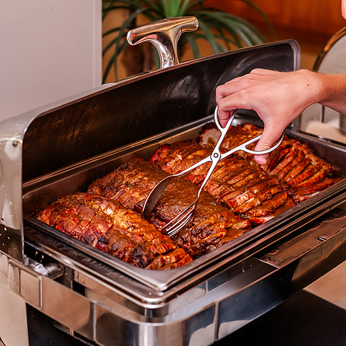 Carne asada en bufet de hotel, servida con pinzas, ideal paraAxis: Corporate