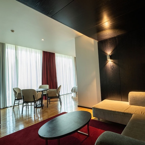 a living room with a couch a table and chairs