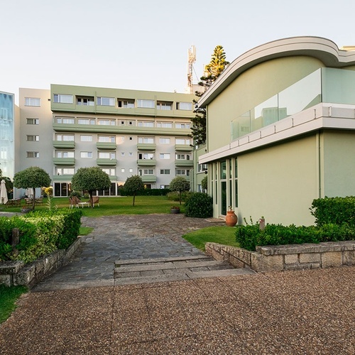 a green building with a balcony on the side of it
