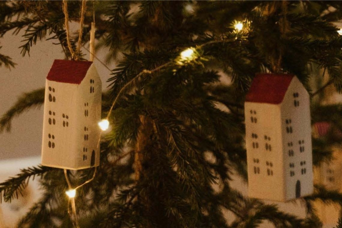 a glass of red liquid with a straw on the beach