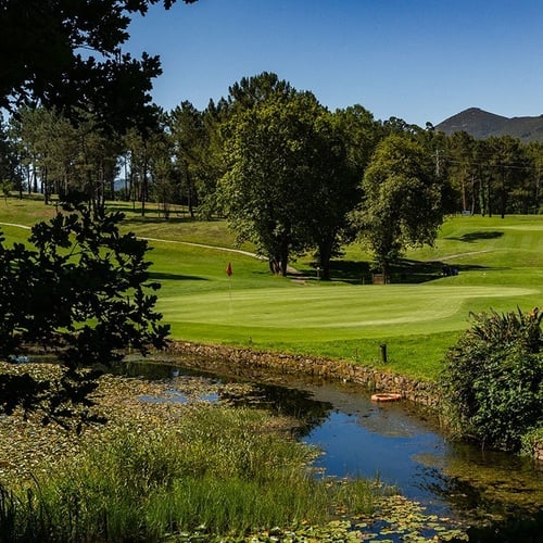 a golf course with a river running through it