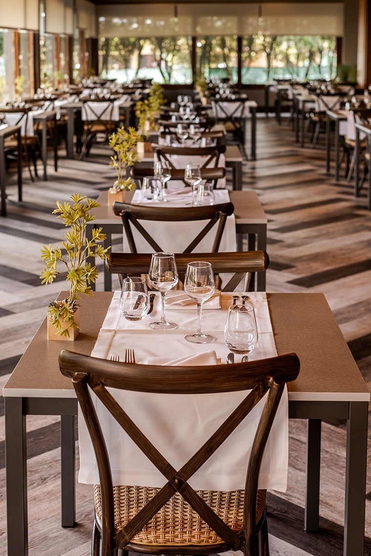 a restaurant with tables and chairs set for dinner