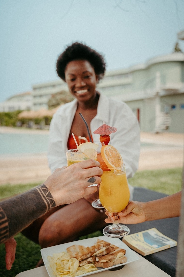 um grupo de pessoas brindando com bebidas tropicais