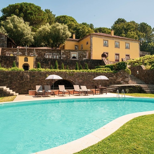 a large house with a swimming pool in front of it