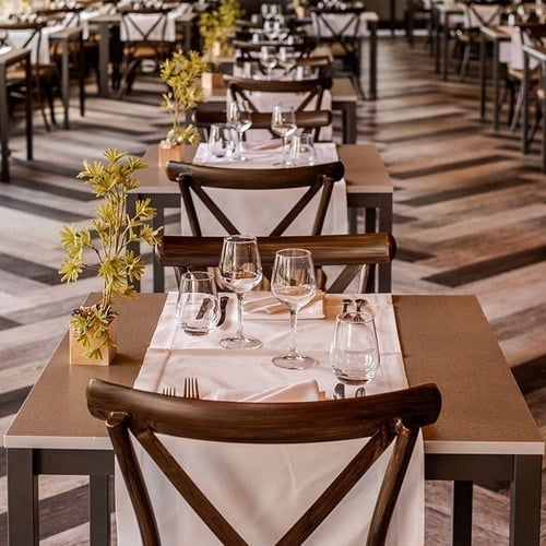 a restaurant with tables and chairs set up for dinner