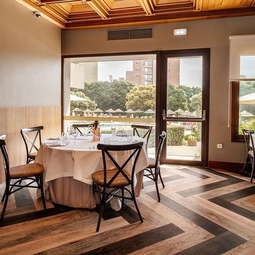a dining room with tables and chairs and a large window