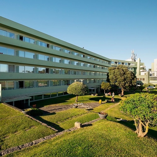 a large green building with a lot of windows