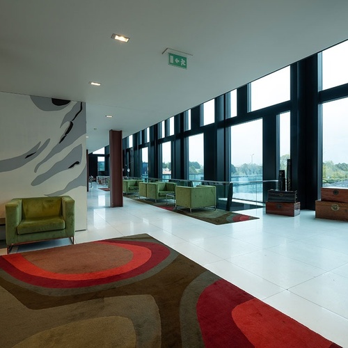 a room with a green exit sign on the ceiling