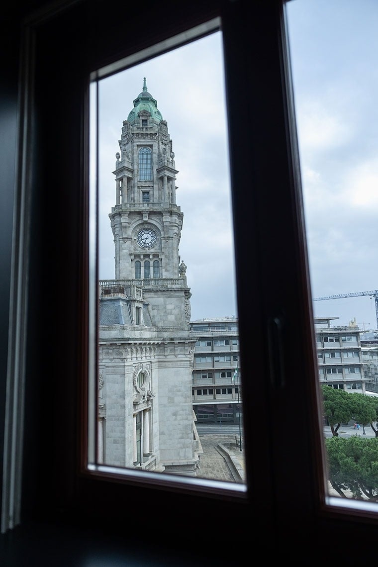 a large clock tower is visible through a window