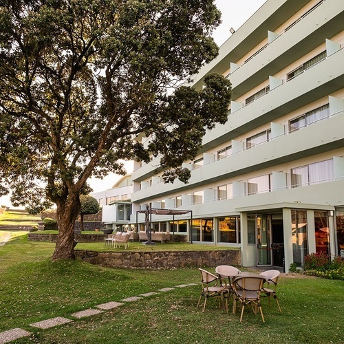 a large building with a tree in front of it