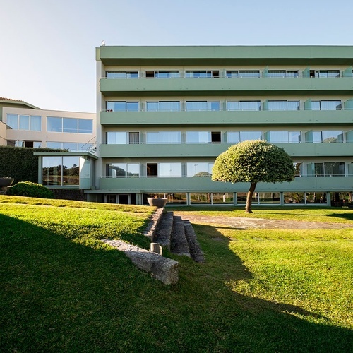 a large green building with a lot of windows